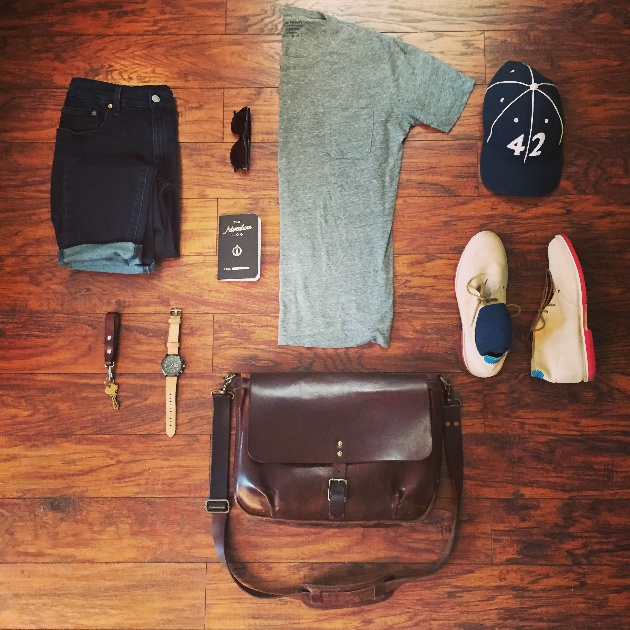 A casual, comfortable Friday travel outfit. Slim Mailbag by Satchel & Page. T-shirt in Heather Grey and Colorblocked Socks by Richer Poorer. Slim Staple Denim by Mott & Bow. Tan Suede Chukkas by Blu Kicks. Hawker Hunter II Watch by AVI-8. Vintage ballcap by Goorin Brothers. Leather lanyard by Tanner Goods. Sunglasses by Steven Alan Optical. Adventure Log by Word Notebooks.